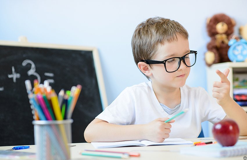 7 years old boy counting on fingers.